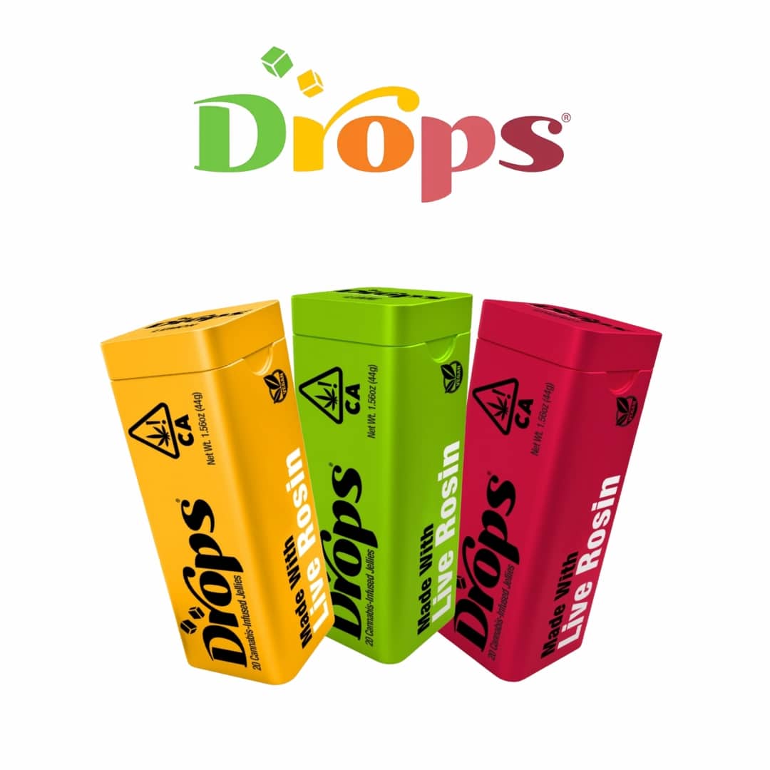 Colorful Drops cannabis edible packages featuring flavors like Blueberry Muffin, Tropical Punch, and Watermelon, with vibrant gummy candies displayed in front.