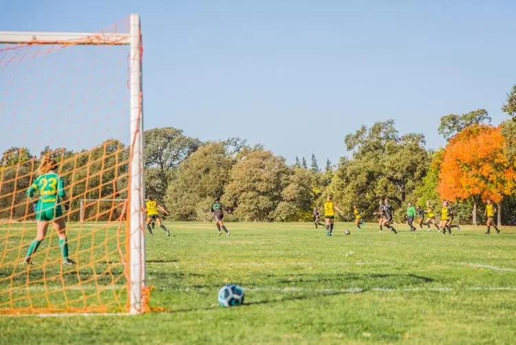 Youth soccer match at Cherry Island Soccer Complex in Elverta, CA — large field surrounded by trees and natural landscape.