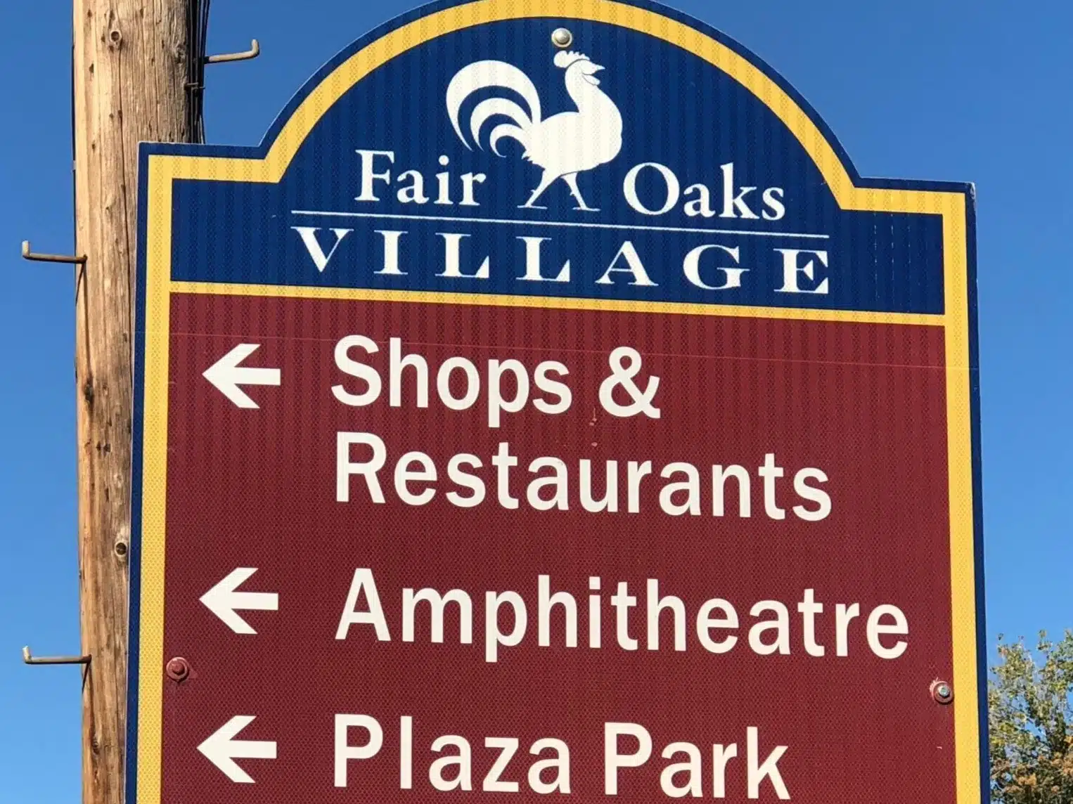 Fair Oaks Village sign showing directions to shops, restaurants, amphitheater, and Plaza Park in Fair Oaks, CA