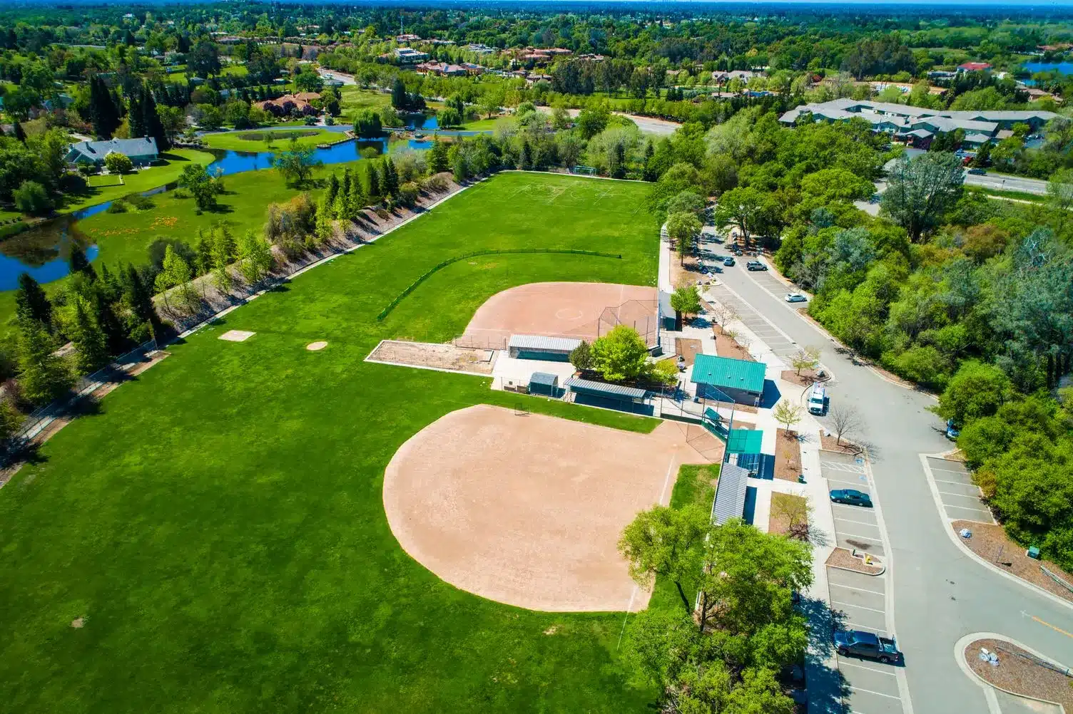 Aerial view of Granite Bay Community Park with baseball fields, green lawns, and nearby ponds in Granite Bay, CA