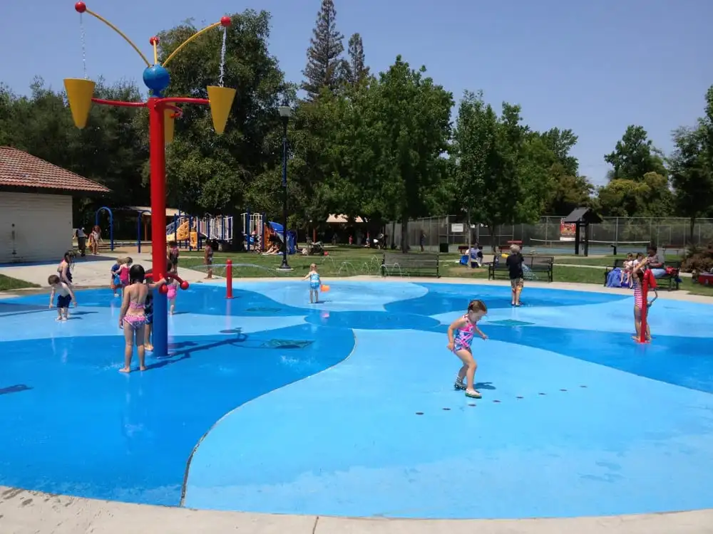 Splash pad and families enjoying Swanston Park in Arden Arcade, CA