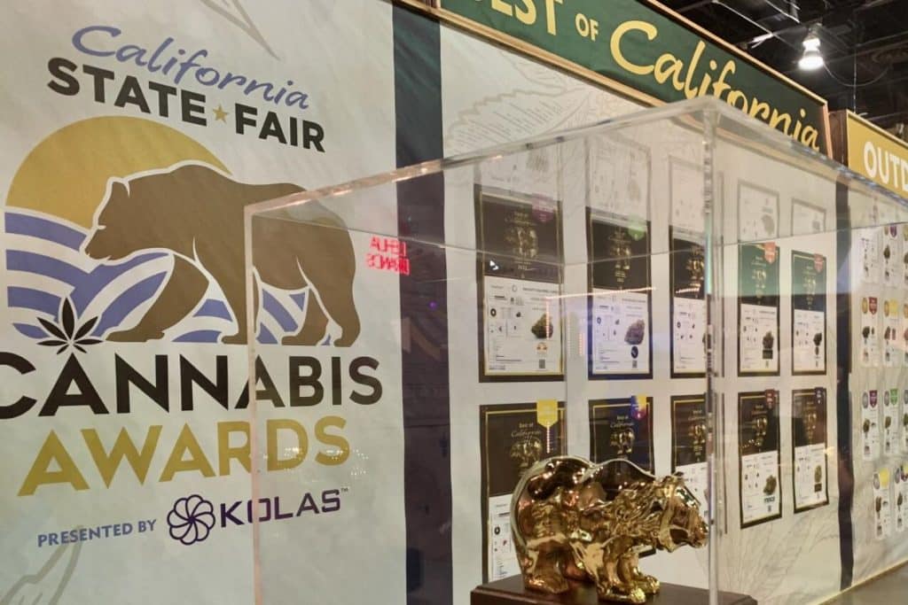 Display of California State Fair Cannabis Awards featuring the official logo, Golden Bear trophies, and framed lab results of winning cannabis strains.